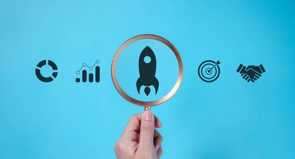 magnifying-glass-focuses-on-rocket-for-business-su-